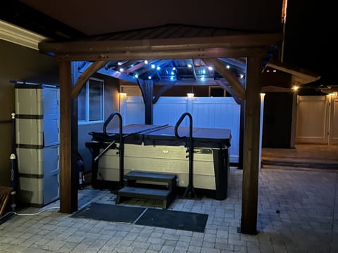 Covered hot tub with overhead mood lighting