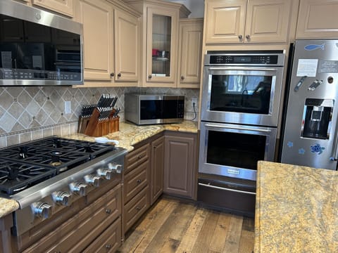 Double ovens (one convection), 6 burner stovetop, 2 microwaves
