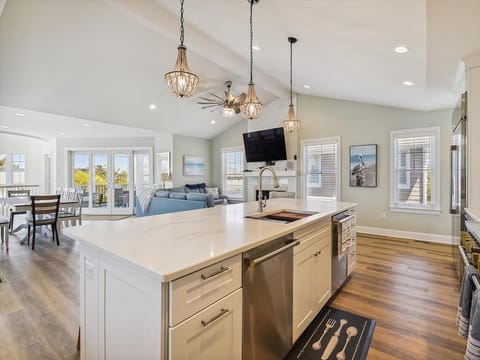 Open-concept kitchen and dining area with pendant lighting and ample counter space, perfect for socializing while cooking.
