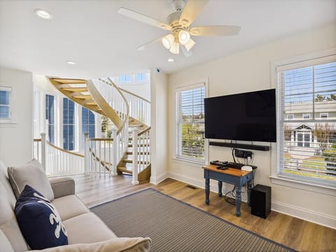 Spacious living room on the first floor with natural light and comfortable seating, perfect for family gatherings or movie nights.