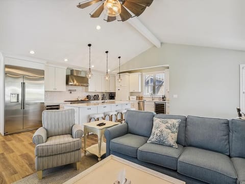 Elegant living space on the upper level featuring a cozy fireplace and large TV, ideal for relaxing evenings at home.