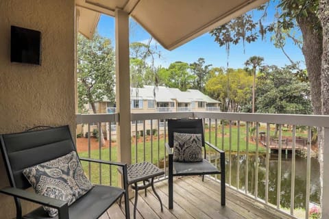 An inviting outdoor space featuring comfortable seating and decorative pillows. 