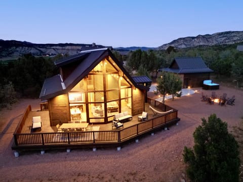 Stunning cabin retreat with expansive windows, a wraparound deck, and breathtaking mountain views.