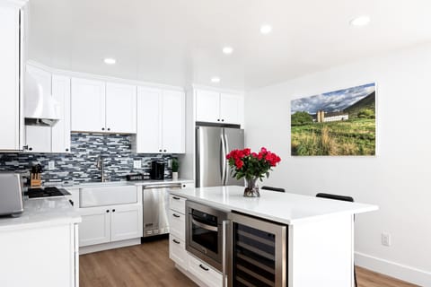 - Fully equipped kitchen with stainless steel appliances and island  
- Coffee bar setup adds convenience for mornings in the mountains  
- Bright backsplash and modern finishes for stylish cooking space