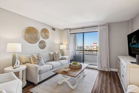 Living room with sleeper sofa, tv, and beautiful Harbour Town views