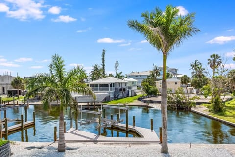 Peaceful waterway with private dock access and swaying palms. Our dock is available for tie-off only.
