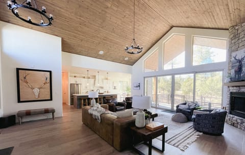 Spacious mountain retreat with soaring ceilings, floor-to-ceiling windows, and cozy modern-rustic design—perfect for gathering with friends and family