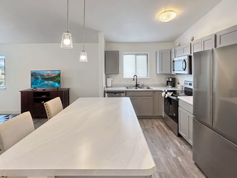 Spacious kitchen with full fridge, oven, and dishwasher