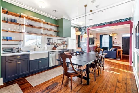 Bright and inviting kitchen with a dining table, full set of appliances, and all the cookware, dishes, and utensils you need to prepare meals with ease.