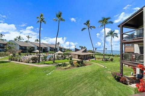 Beautifully landscaped grounds with clear blue skies and lush greenery