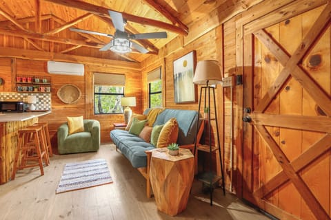 To the right of the entry door is the living room of the cabin.