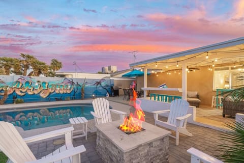 Gather around the fire pit while the pool glows nearby and string lights set the mood for the evening.