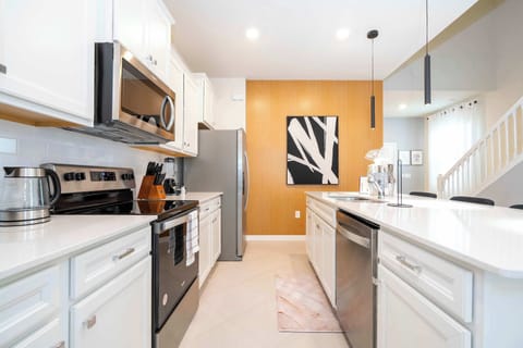 Share family meals in a modern kitchen equipped with stainless steel appliances.