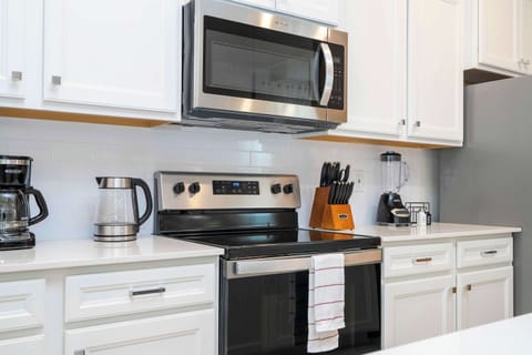 Share family meals in a modern kitchen equipped with stainless steel appliances.