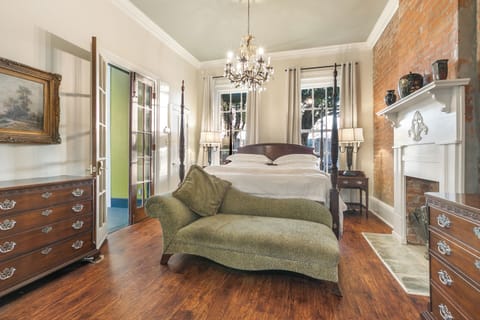 Elegant king bedroom with soaring ceilings and inviting decor