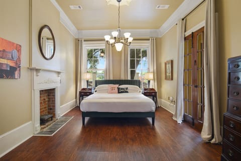 Grand king bedroom with 11-foot ceilings, a chandelier, and a private porch