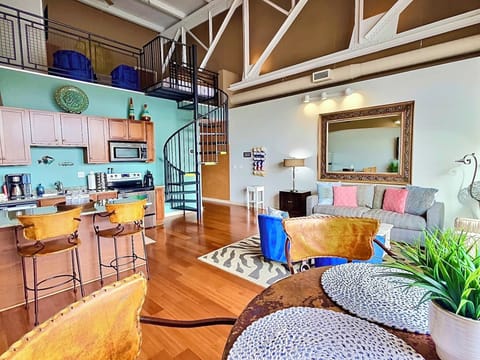 Coastal-Inspired Loft Retreat
A mix of industrial charm and coastal elegance, this open-concept loft features a fully equipped kitchen, cozy seating, and a stylish spiral staircase leading to a private loft.