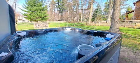 Fenced yard with hot tub and playset