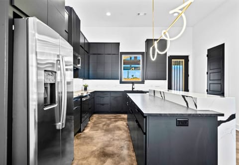 A beautifully designed kitchen with crisp lines, top-of-the-line appliances, and plenty of counter space, offering both functionality and aesthetic appeal.