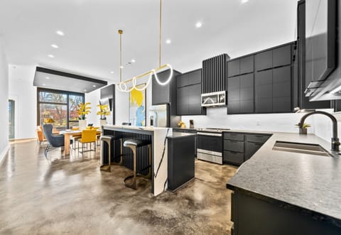 The open kitchen design balances function and style with modern appliances, sleek finishes, and plenty of room for cooking or entertaining.