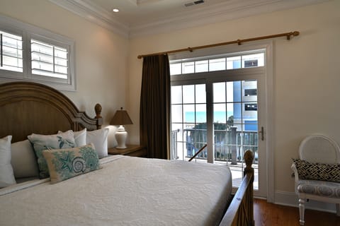 King Bedroom with balcony doors and bright natural morning light