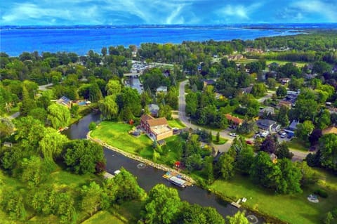Scenic canal in backyard to the Lake with private dock, kayaks, and pedal boat.