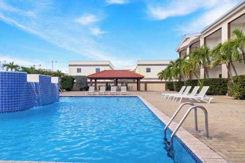 Unwind by the shared swimming pool, complete with sun lounges for the ultimate relaxation – a perfect Airbnb escape!
