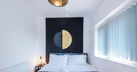 A serene sanctuary featuring a comfortable bed, gentle lighting, and minimalist décor. Clean lines and organized storage make it an ideal space to unwind and recharge."