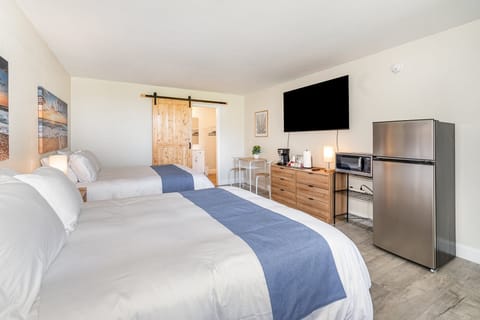 Comfort meets convenience. Enjoy a modern space equipped with two full beds, a flat-screen TV, and a practical kitchenette for your morning coffee and quick snacks.