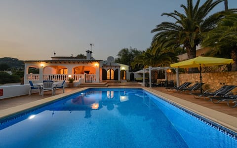 Illuminated pool with Roman stairs and beautiful view of the surroundings.