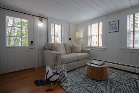 A bright, cozy living room with a comfortable two-seater couch.