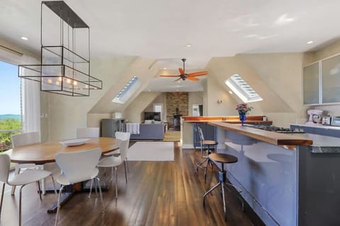 Open kitchen and dining area with seating for six at the table.