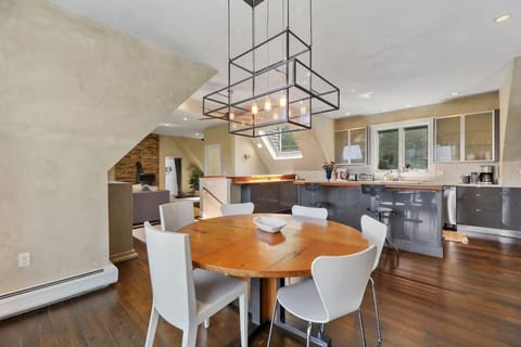 Kitchen and dining area with space for six at the table and three at the kitchen counter.
