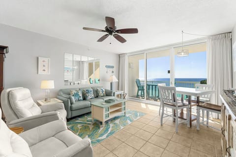 Relax in this bright living room with ocean views and access to a balcony.