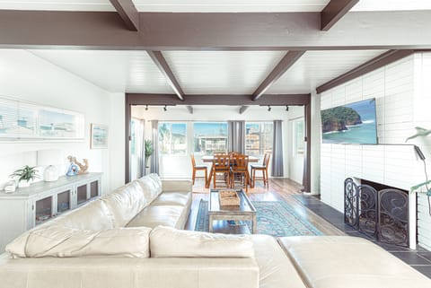 Expansive great room with beamed ceilings and seamless indoor-outdoor flow
                