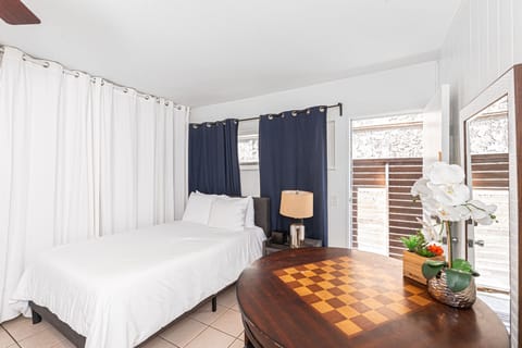 One of two full-size beds, dressed in crisp linens for restful stays
                