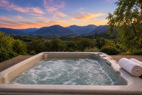 Private hot tub with hilltop views. Included only for reservations meeting eligi