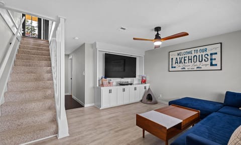 Lower level living room with large smart Tv, popcorn machine, and record player.
