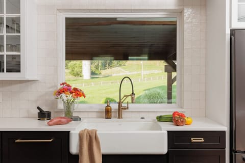 The large kitchen sink makes cleanup enjoyable with this beautiful farm view.