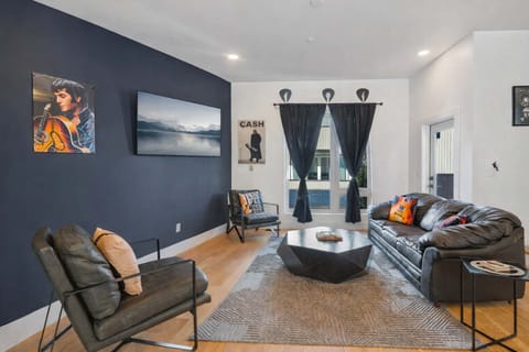 Stylish space featuring leather seats, wood floors, and monochrome walls.