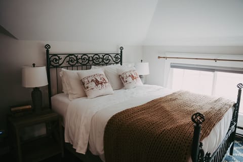 Rock Creek Apartment #6- A cozy queen bed worth coming back to at the end of a long Montana day.
