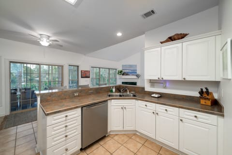 The kitchen is open to the great room. Sliding doors lead out to the screen porch