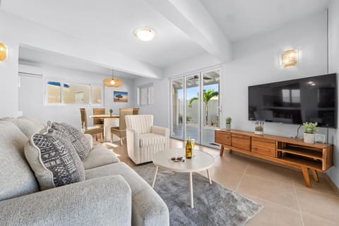 Unwind on a plush sofa in the sunlit living room with a 55” Smart TV. Enjoy cozy moments with loved ones or step outside to your private backyard oasis.