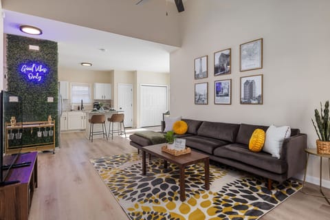 Plush living room with beverage cart at the corner + a peek of the kitchen