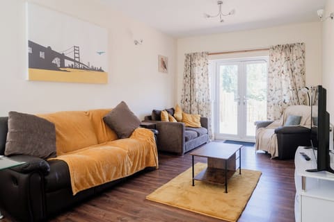 Large bright living area with plenty of comfy seating leading out to an extensive garden.