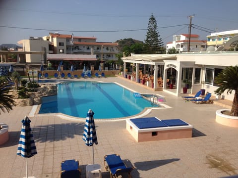 Outdoor pool, a waterfall pool, open 8 AM to 8 PM, pool umbrellas