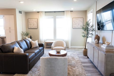 Cozy and inviting guest bedroom with soft, neutral tones and natural light streaming through – the perfect place to relax and unwind.