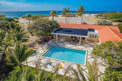 Your place along Aruba’s legendary Golden Mile — private pool, lush gardens, and the Caribbean sea just steps away.