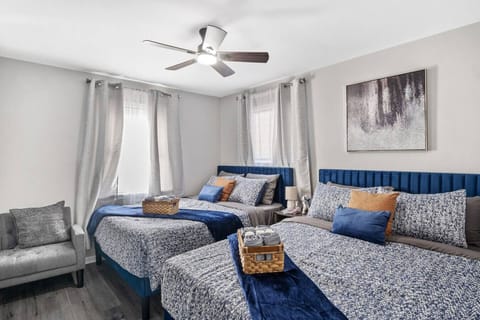 Cozy and functional with two queen beds, flat screen Roku TV, an extra seating area, ceiling fan, and ample storage.