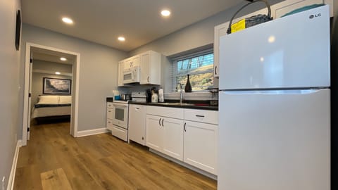 Cook with ease in this fully equipped kitchen, conveniently located near the cozy bedroom for a seamless stay!